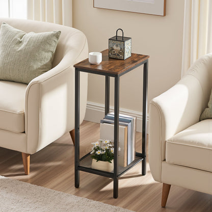 Small wooden side table with decorative items between two beige armchairs in a living room.