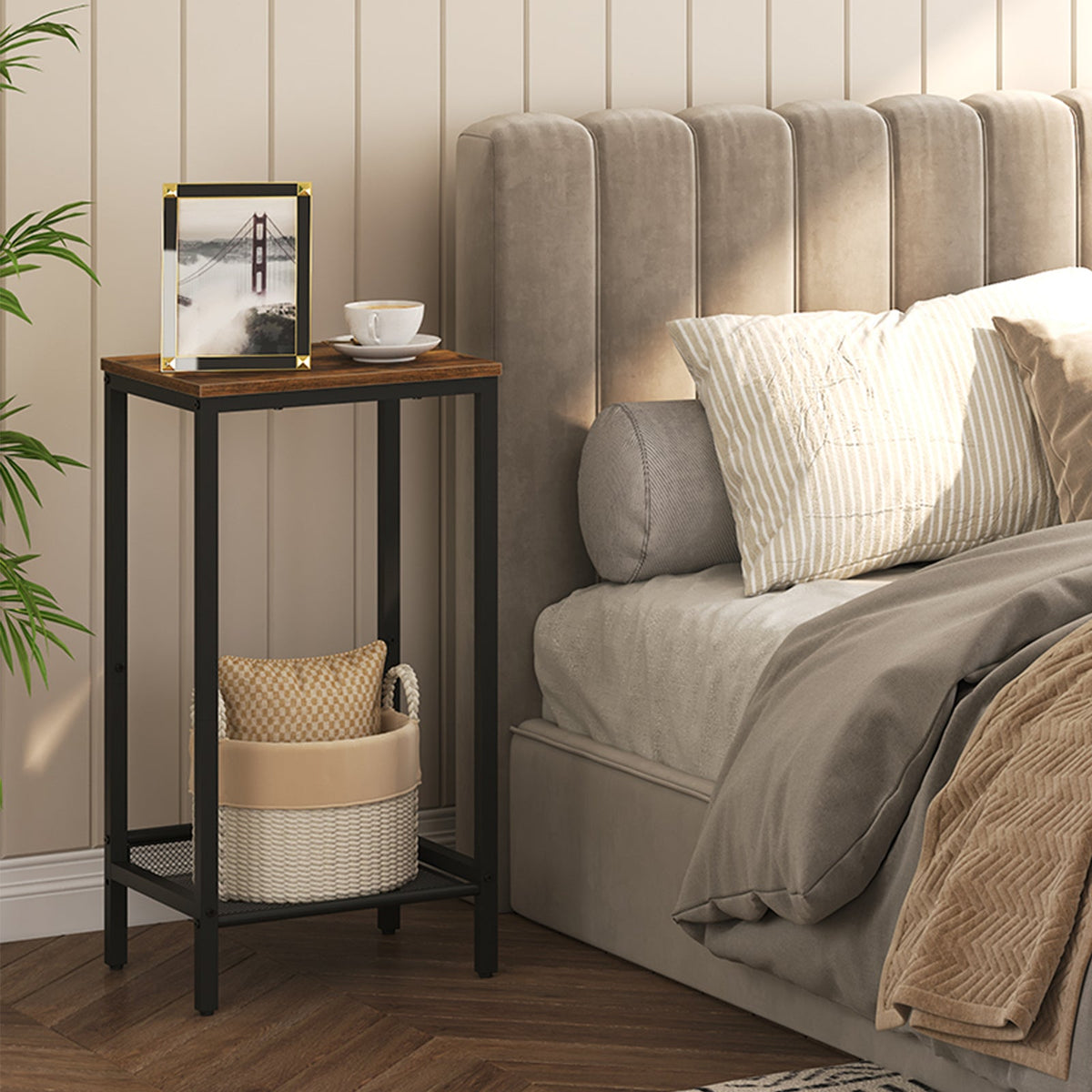 Bedroom with a side table, bed, and decorative items.