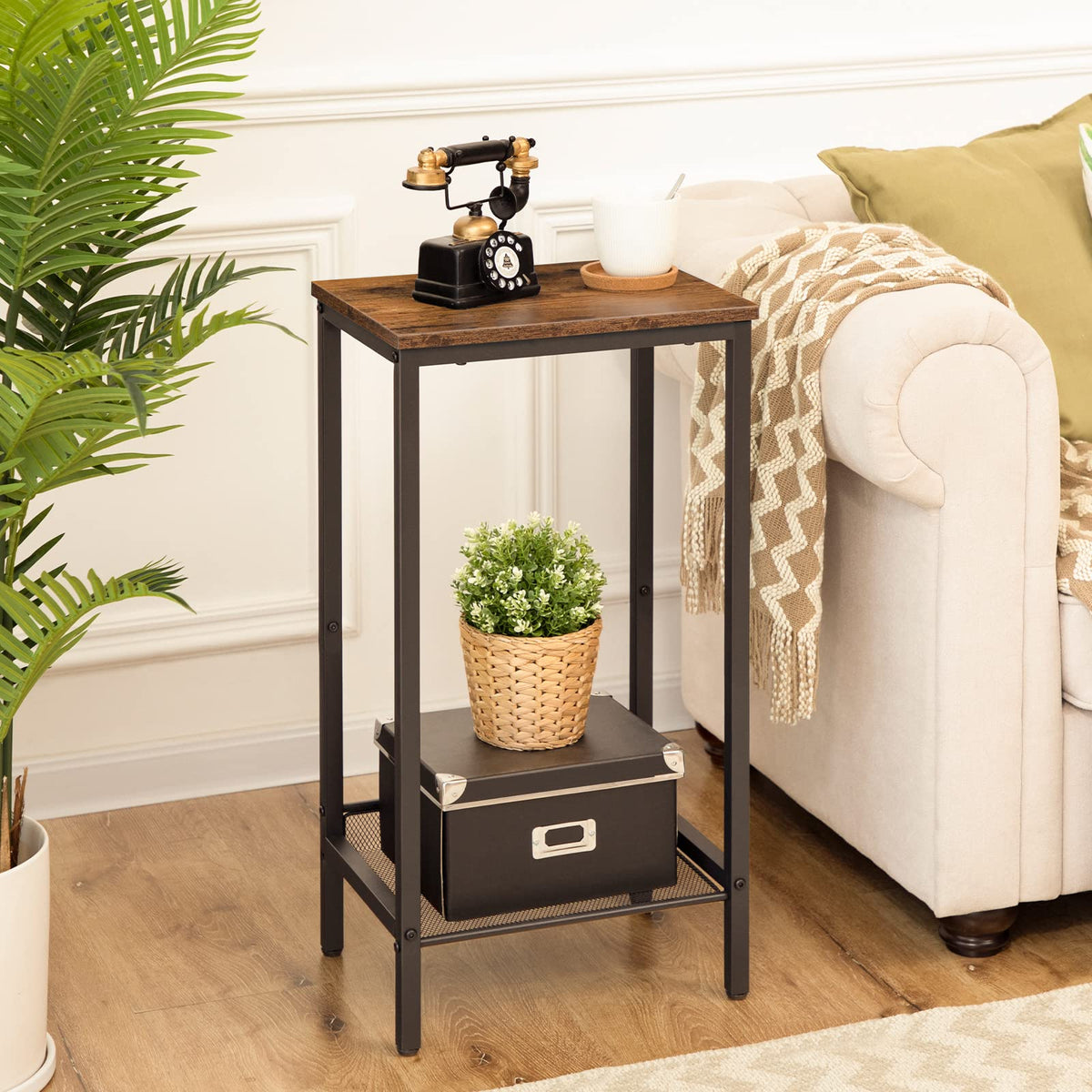 Small wooden side table with decorative items in a living room setting